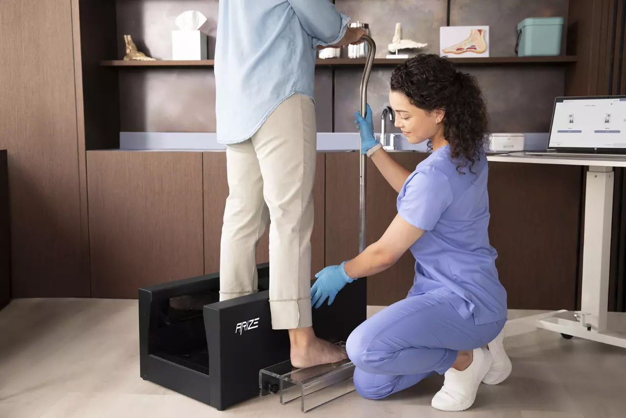 Healthcare professional using HP Arize 3D foot scanner with a patient